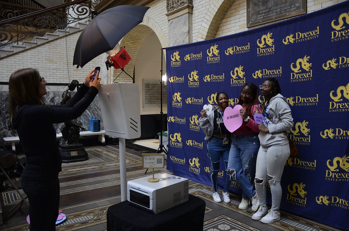 Camryn Armstrong, Amayia Lowe and Amaya Jenkins take a photo with Drexel props. 