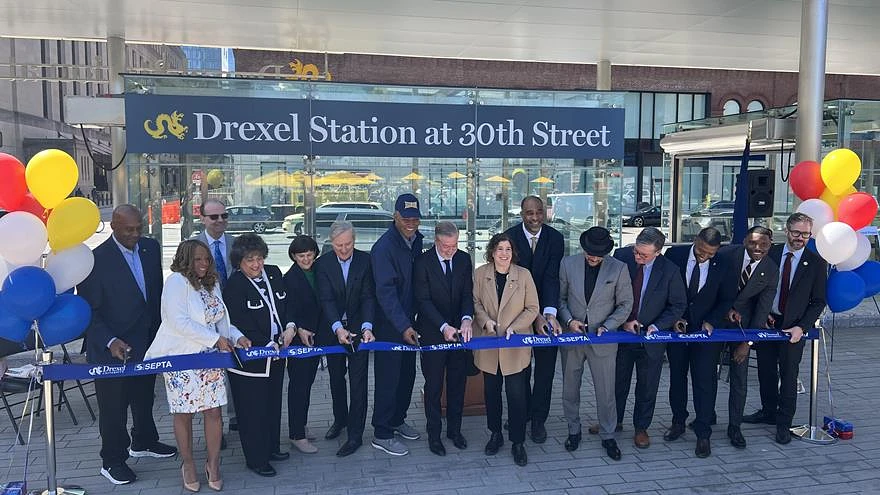 Elected officials and representatives and leaders from SEPTA, Brandywine Realty Trust and Drexel University, including Drexel University President John Fry, eighth from left, at the ribbon-cutting ceremony in front of the new Drexel Station at 30th Street on April 8. Photo courtesy SEPTA.