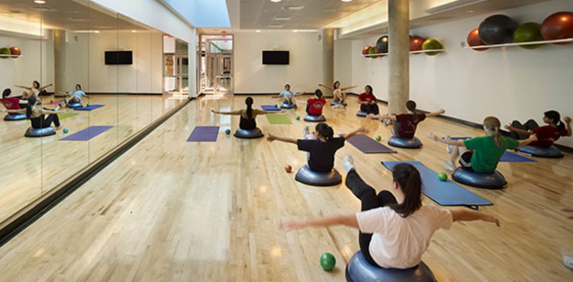 Students practicing yoga in a classroom