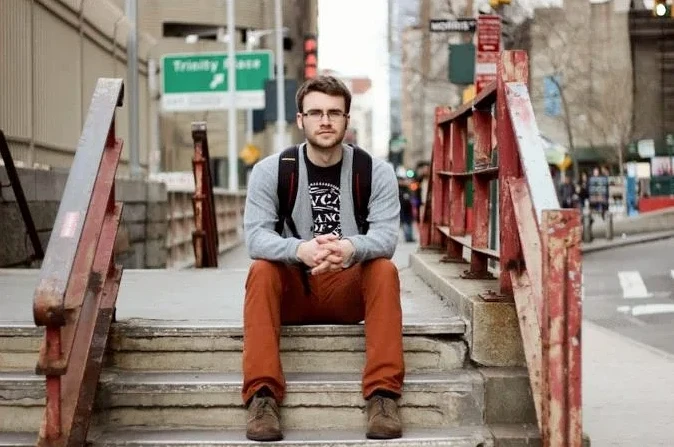 Student sitting outside on stairs